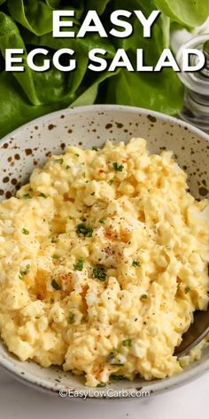 an egg salad in a bowl with lettuce on the side