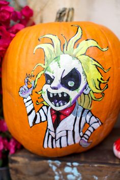 a painted pumpkin with a clown face on it