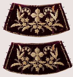 two pieces of velvet with embroidered flowers and leaves on the sides, one is purple