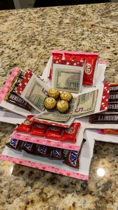 some candy bars and money are sitting on top of each other in front of a counter