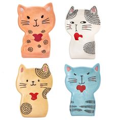 four ceramic cats with different designs on them