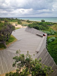 an aerial view of a skateboard park with the ocean in the background