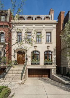 this is an image of a two story house in the city with stairs leading up to it