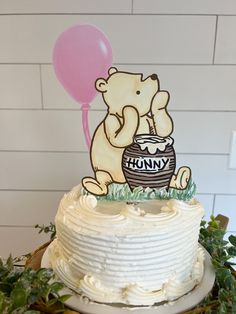 a birthday cake with a teddy bear holding a pink balloon and the words humpy on it