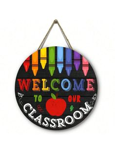 a sign that says welcome to our classroom with crayons and an apple on it