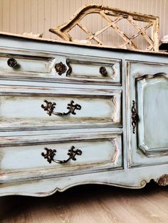 an old dresser is painted blue and white