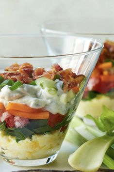 there is a salad in a glass bowl on the table next to other food items