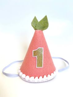 "This peach MINI birthday party hat is the perfect accessory for your little one's big day, cake smash or photo session. All hats are made to order. Each hat along with the bows and embellishments are carefully handcrafted so each hat is unique and will vary slightly because of this. Great for the following themes: Sweet as a Peach, Our Little Peach, Sweet One, Peaches and Cream. PLEASE LEAVE YOUR EVENT DATE AT CHECKOUT. PARTY HAT FEATURES: -Mini Party Hat (approximately 3\"x5\")  -Peach felt-co Fun Pink Birthday Costume Hats And Headpieces, Cute Adjustable Hat For First Birthday, Cute Pink First Birthday Party Supplies, Whimsical Pink Birthday Party Supplies, Adjustable Mini Hats With Round Crown For Birthdays, Adjustable Pink Costume Hat For Birthday, Whimsical Adjustable Costume Hats For Birthday, Adjustable Mini Hats With Round Crown For Birthday, Adjustable Round Crown Mini Hats For Birthday