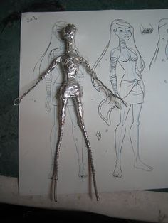 a drawing of a human figure is shown next to a piece of paper with drawings on it