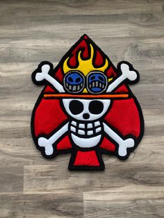 a patch with a skull wearing goggles on it's face and flames in the eyes