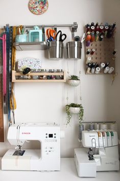 a sewing machine sitting next to a shelf with scissors and other crafting supplies on it