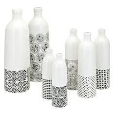 a group of white vases sitting next to each other