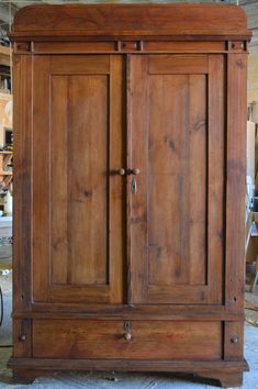 an old wooden armoire sitting in a room