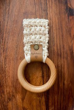 a crocheted wooden ring on top of a wooden table