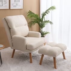 a chair and footstool in a living room with a potted plant on the floor