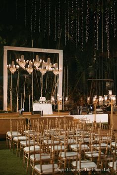 an outdoor wedding setup with white linens and gold chairs