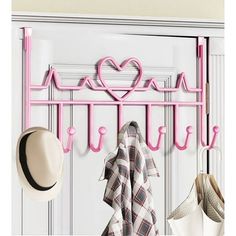 a pink coat rack with hats and scarves on it