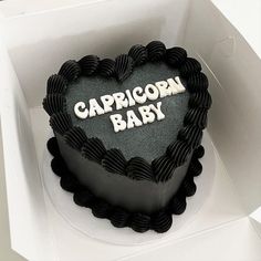 a heart shaped cake with the words capricorn baby on it in a box