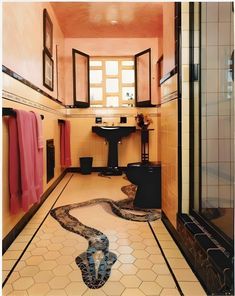 a bathroom that has a snake skin pattern on the floor