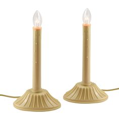 two small candles are sitting next to each other on a white background, one is turned off and the other is turned off