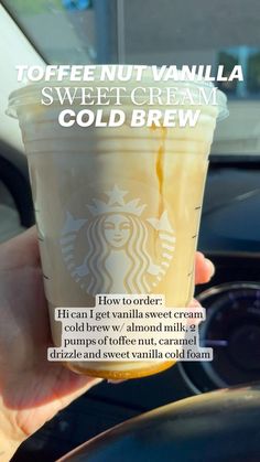 a person holding up a cup of coffee in their hand with the caption toffee nut vanilla sweet cream cold brew