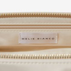 The Alexandra was made in collaboration with FabFitFun. Designed in a pillowy and soft silhouette, this top handle bag is made with vegan leather and features an interior zip pocket. Vegan Leather 12"L x 6.375"H Handle Drop: 3.5" Zipper Closure Gold-Tone Hardware Interior Zip & Slot Pocket Fits up to an iPhone 11 Pro Max Product No. FF2024CRM Luxury Cream Top Handle Shoulder Bag, Chic Cream Top Handle Bag, High-end Cream Top Handle Bag, Cream Top Handle Bag With Bamboo Detail, Cream Top Handle Bag With Gold-tone Hardware, Melie Bianco, Handle Bag, Top Handle, Vegan Leather