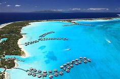 an aerial view of the resort and its surrounding lagoons in the middle of the ocean