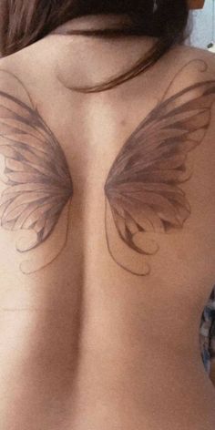 the back of a woman's breast with wings drawn on her upper half and chest