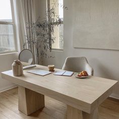 a wooden table sitting in front of a window