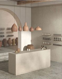 an empty room with several vases and bottles on the wall, along with shelves