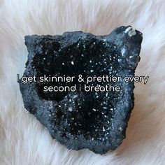 a piece of black rock with the words i get skinnier & prettier every second