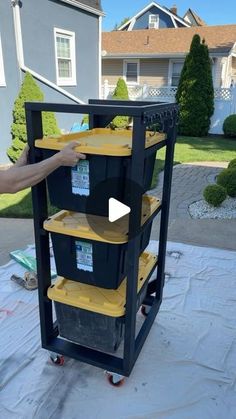 a man standing next to a cart filled with plastic containers