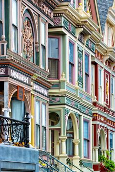 several multicolored buildings with wrought iron railings