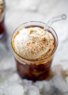 two glasses filled with ice cream on top of a white countertop next to each other