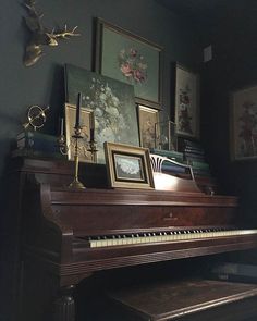 there is a piano in the room with pictures on it