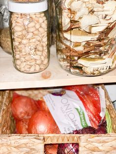 two baskets filled with food sitting on top of a wooden shelf next to each other