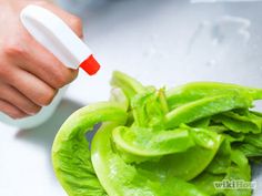 a person using a pepper grinder to cut green peppers