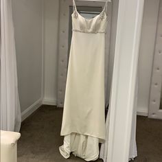 a dress hanging on a hanger in a closet