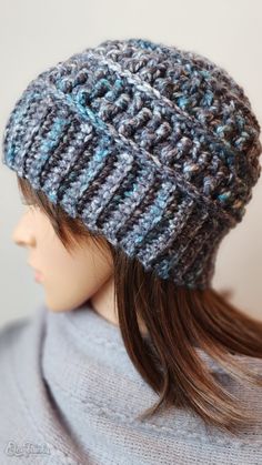 a woman wearing a gray and blue knitted hat