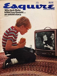 a young boy sitting on the floor in front of a tv eating a hot dog