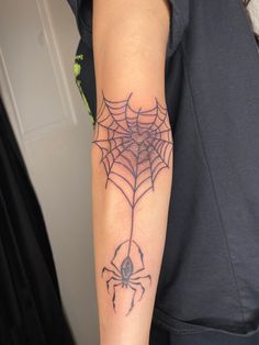 a person with a spider web tattoo on their arm