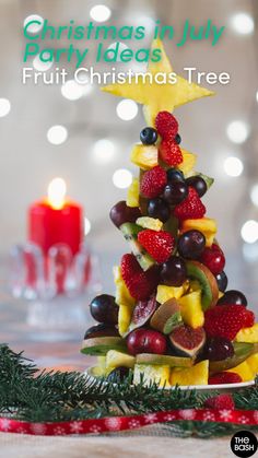 a christmas tree made out of fruit on a table with candles in the background and text overlay that reads christmas in july party ideas