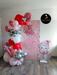 balloons and decorations are displayed in front of a pink wall