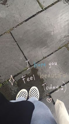 someone's feet on the ground with words written in them