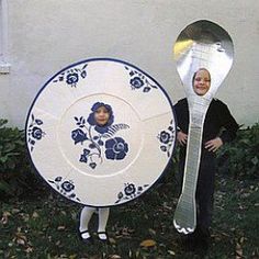 two people holding plates and spoons in front of a house with flowers on them