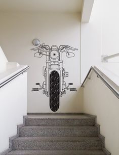 an artistic mural on the side of a building depicts a motorbike, as well as stairs