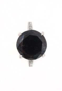 an image of a black diamond ring on a white background with clippings to the side