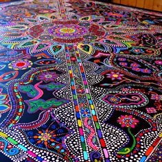 an intricately designed table cloth is on display