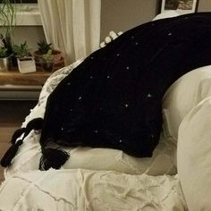 a black and white pillow sitting on top of a bed