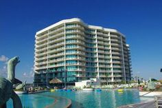 a large building with a pool in front of it